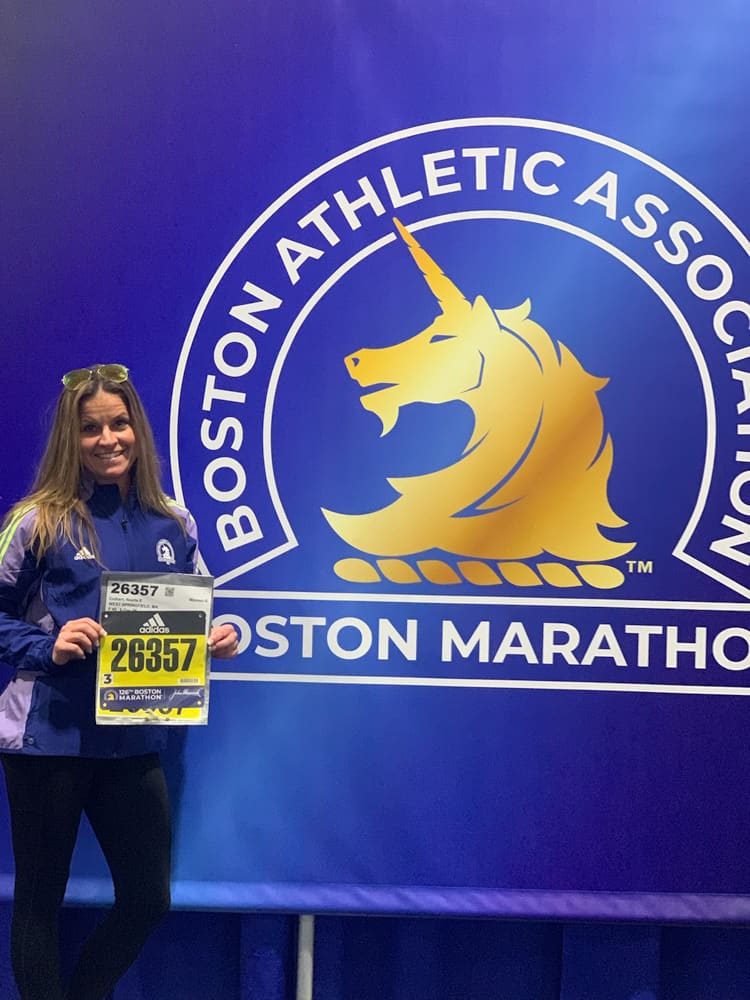 Woman holding race number at the Boston Athletic Associations' Boston Marathon.