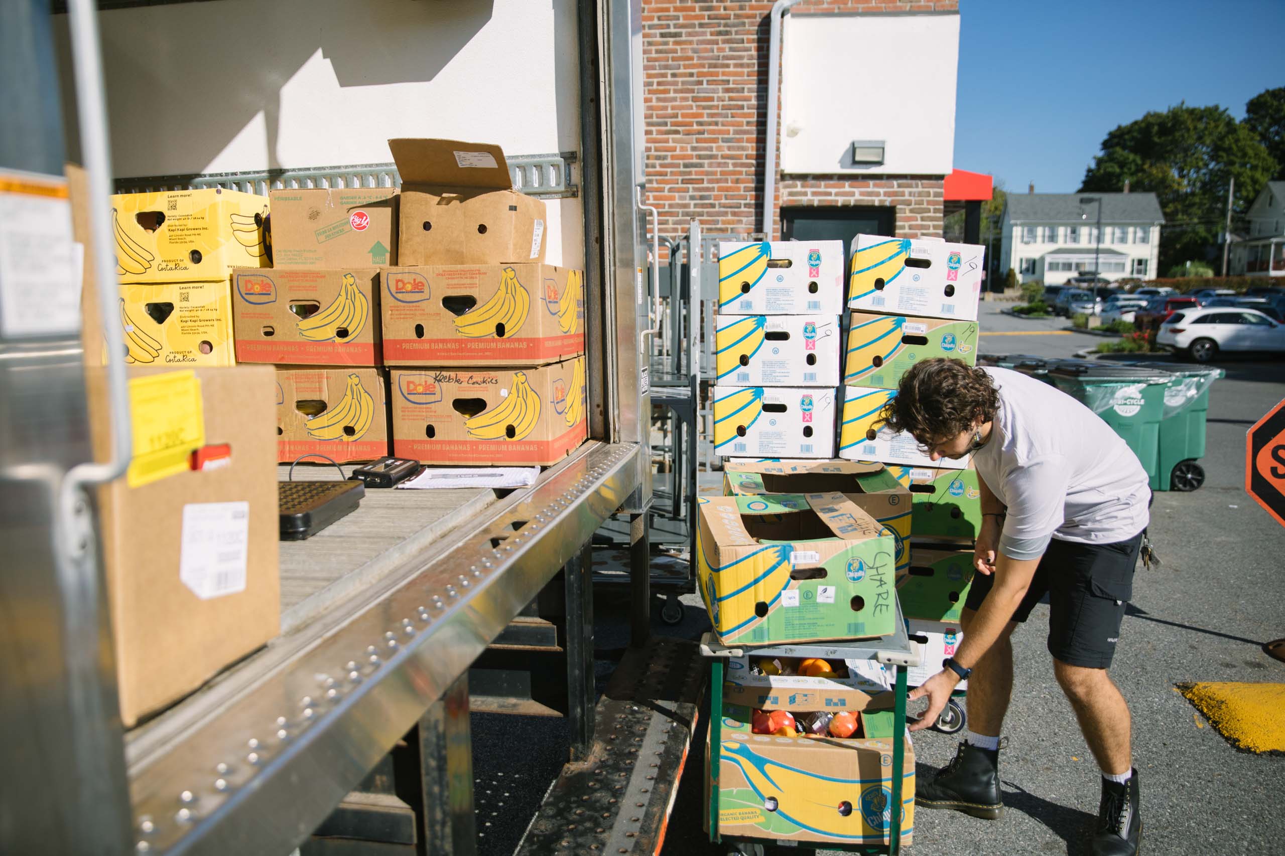 A man loading boxes into a truck while working for Boston area food recovery organization Lovin Spoonfuls.