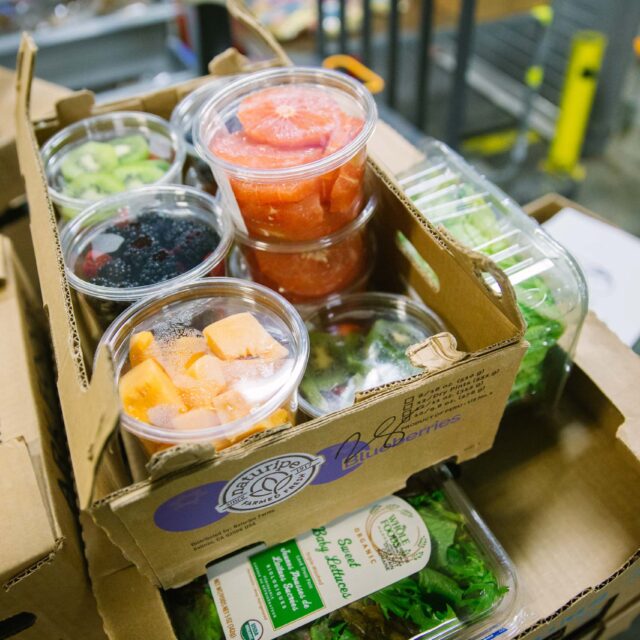 A box of chopped fruit and lettuce donated to Boston area food recovery organization Lovin Spoonfuls.