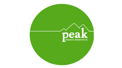 Logo of Peak Organic Brewing Co. showing white text and a mountain design on a green circular background.