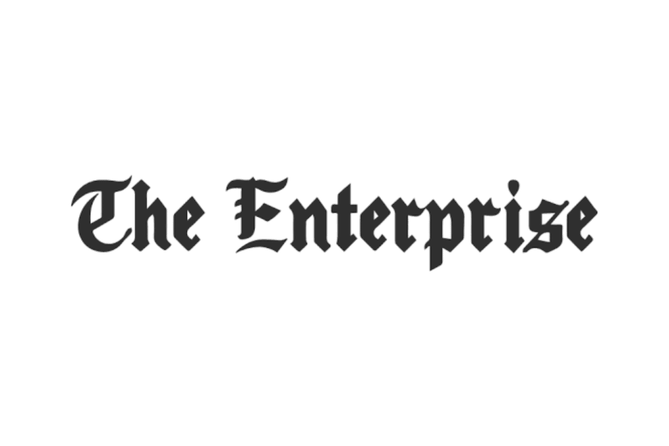 The words "The Enterprise" are written in black, Gothic-style font on a white background.