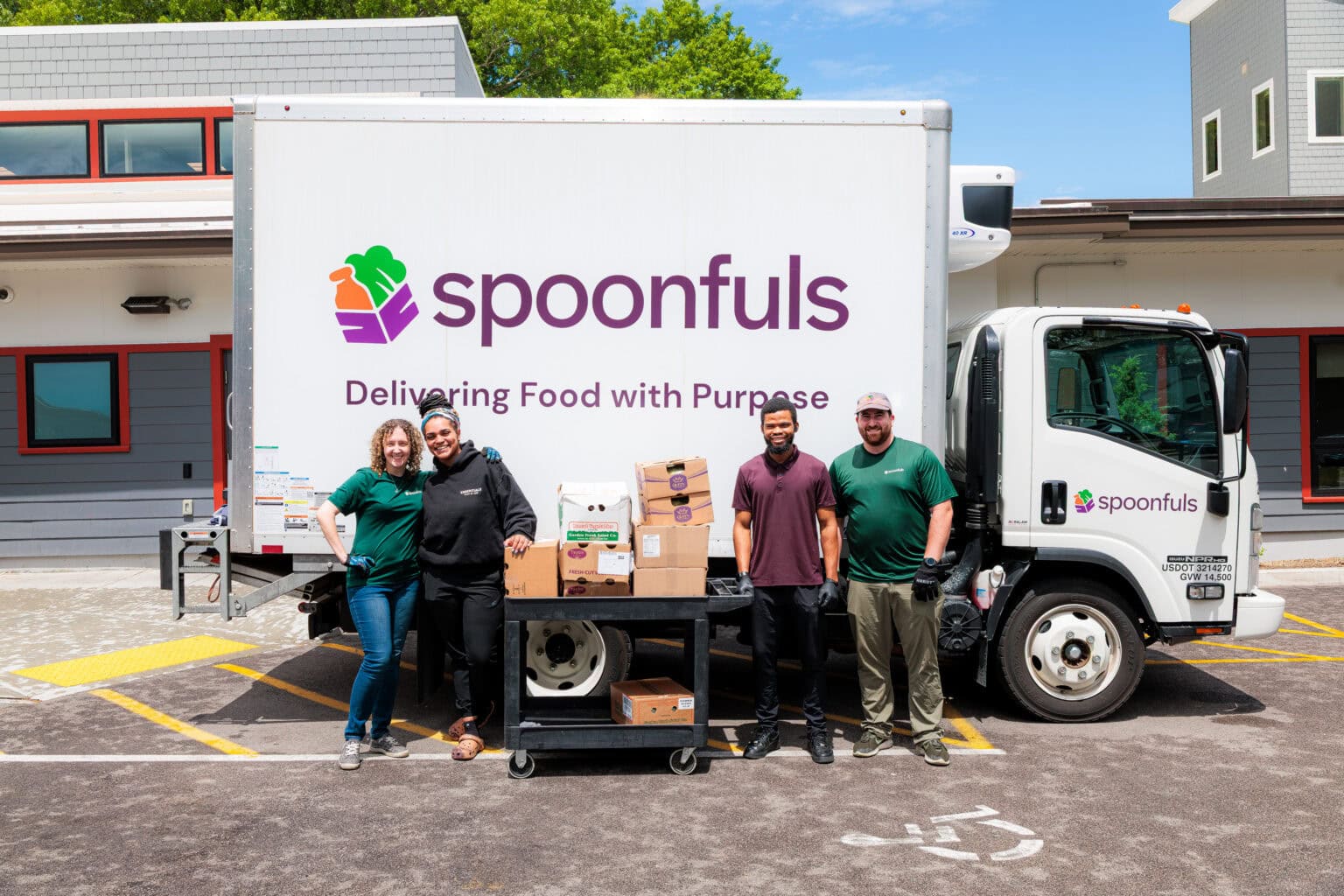 Spoonfuls staff members posing with community partners in front of truck, demonstrating a career in food recovery.